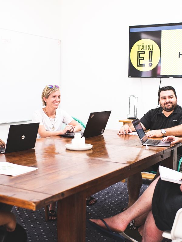 Photo of a group sitting around a wooden table